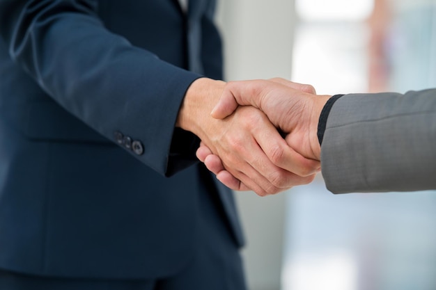 Close-up hand of Businessman handshake for teamwork of business merger partnership and business deal,successful negotiate,hand shake