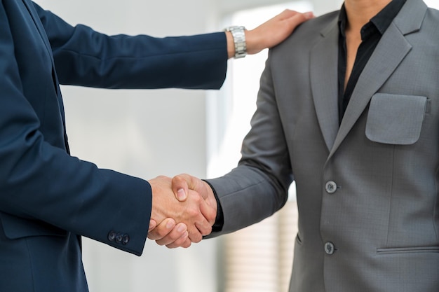 Close-up hand of Businessman handshake for teamwork of business merger partnership and business deal,successful negotiate,hand shake