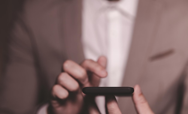 Close up hand of businessman with mobile phone Concept of technoloy for business