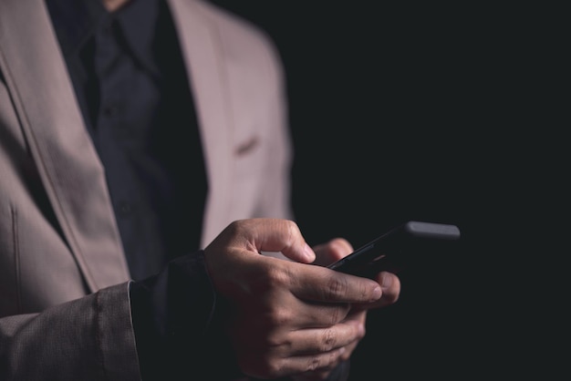 Close up hand of businessman with mobile phone Concept of technoloy for business