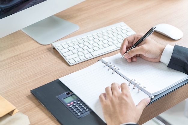 Close-up hand of businessman writing