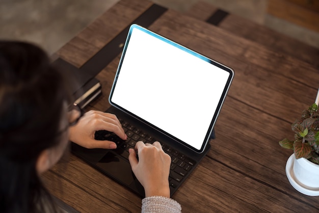 Close up. Hand businesswoman using digital tablet on white screen on table. Mock up.