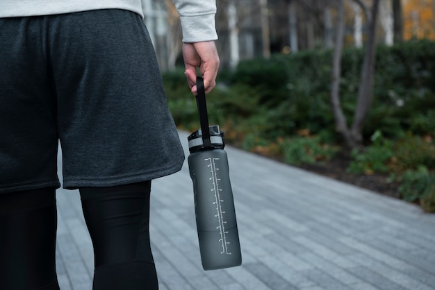 Close up hand carrying water bottle