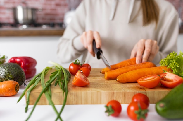 Close up hand cutting carrot