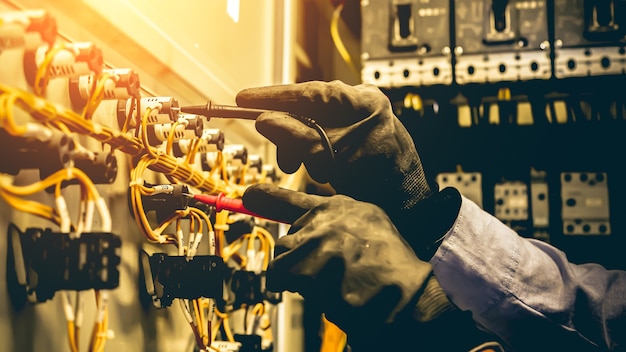 Close-up hand of electrical engineering using measuring to checking electricity.