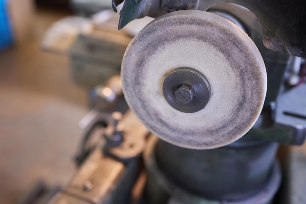 Close up hand heavy industrial worker is working on metal work factory process by performing mechanical turning operation at machine for steel structure industry