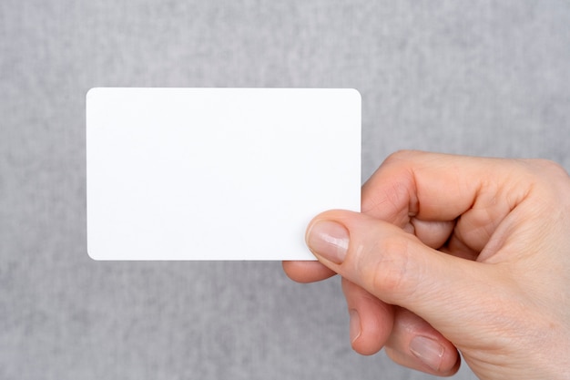 Close up hand holding blank business card