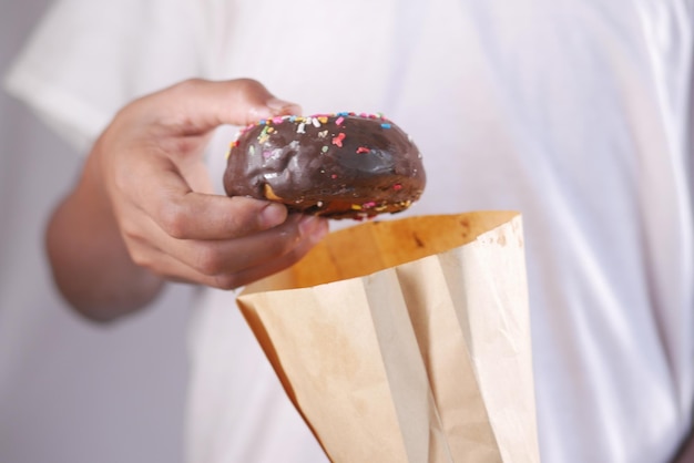 Close up of hand holding donuts