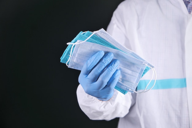 Close up hand holding medical masks with copy space