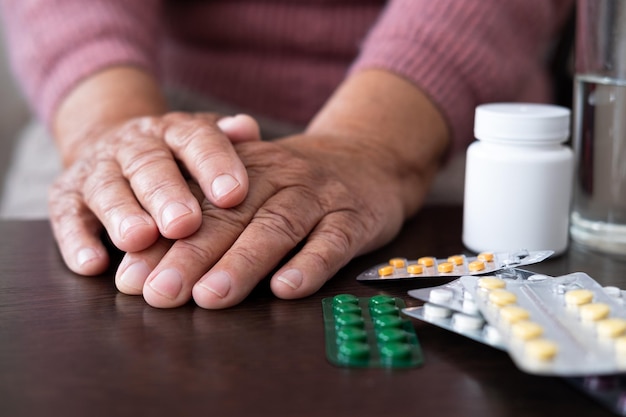 Close up of hand holding pills on black background expensive medicines