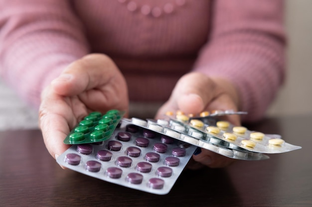 Close up of hand holding pills on black background expensive medicines