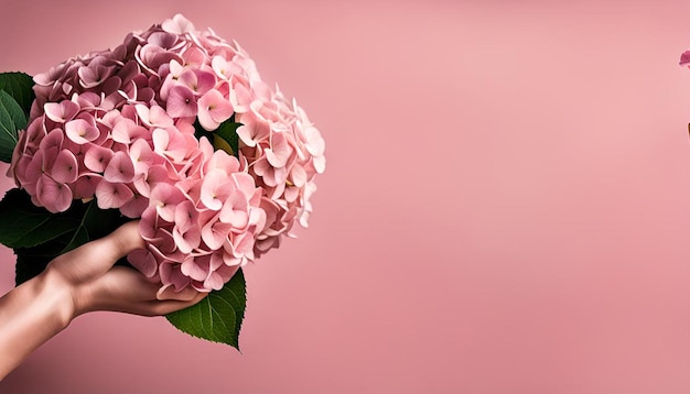 Close up hand holding pink hydrangea bouquet