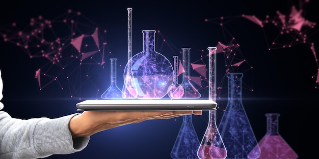 Close up of hand holding tablet with glowing blue scientific low poly network and flasks