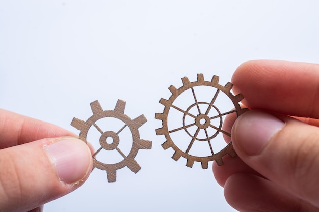 Photo close-up of hand holding wheel against white background