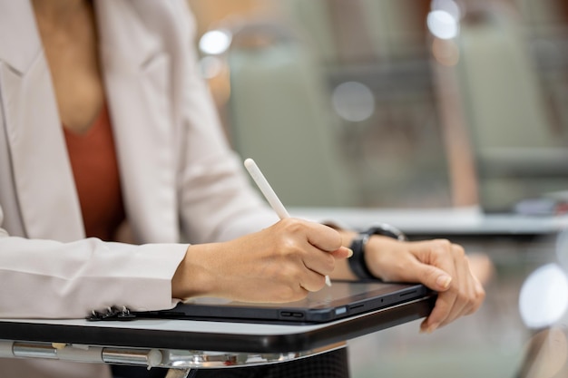 Close up hand man Signature contrac digital tablet in Office Indoors