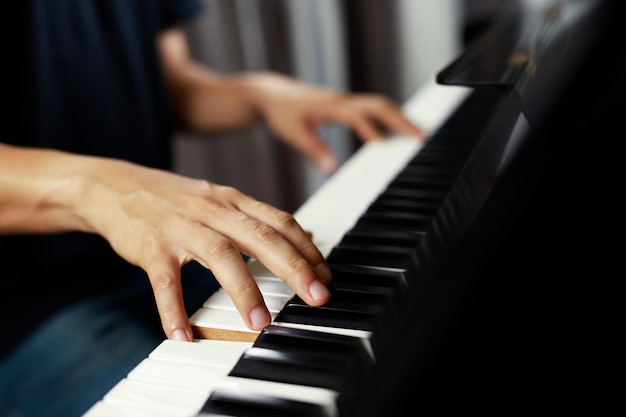 Close up of hand people man musician playing piano keyboard with selective focus keys can be used as a backgroundx9