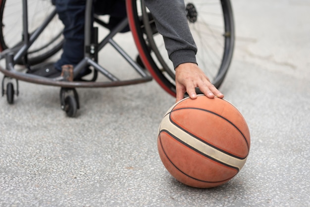 Close-up hand touching basketball