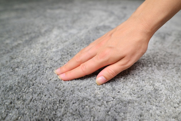 Close up of hand touching soft carpet Gentle and fluffy carpet between fingers