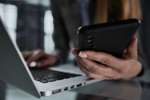 Close up hand using phone screen on workspace table