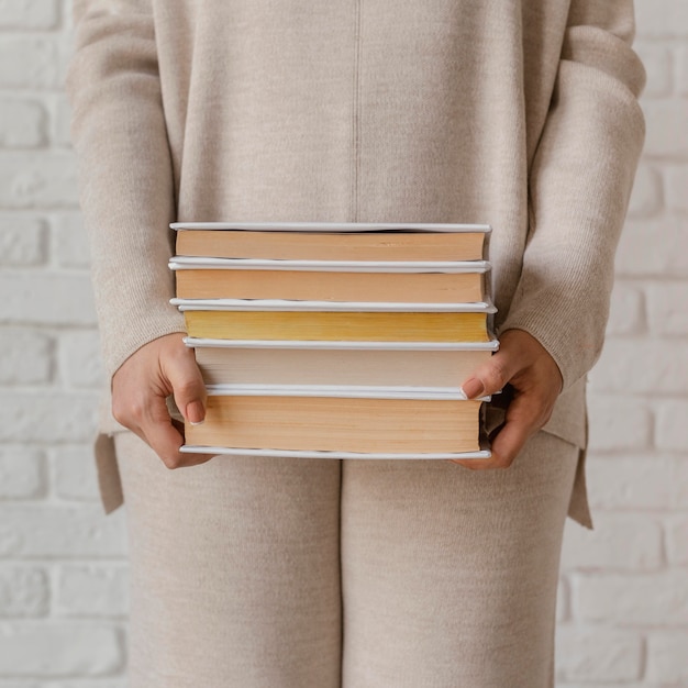 Close up hands holding books stack