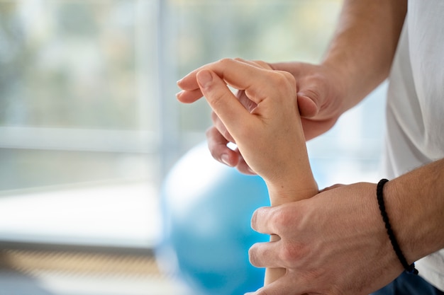 Close up hands holding patient's hand