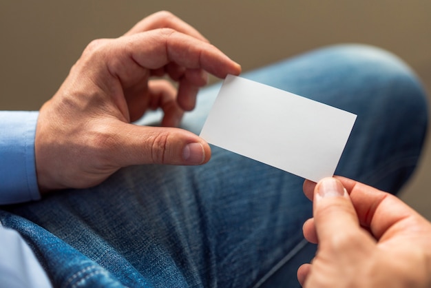 Close-up hands holding white card