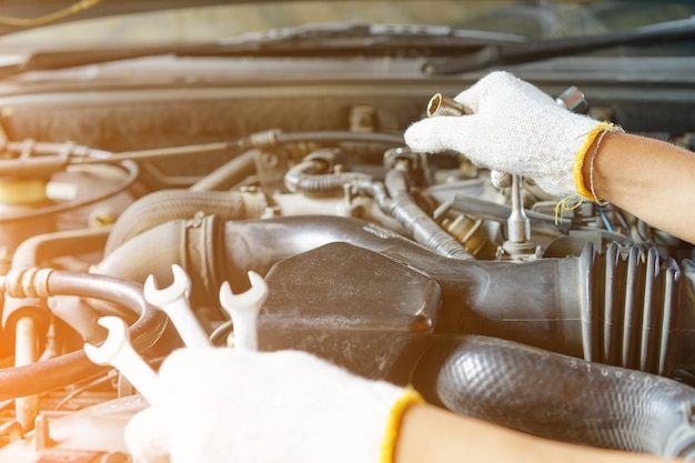 Close up hands mechanic doing car service and maintenance