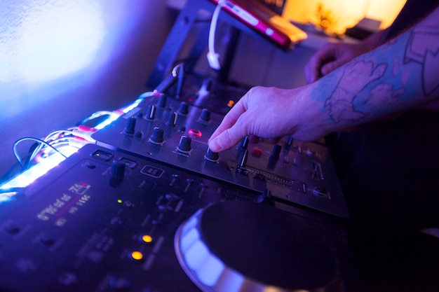 Close up of hands of a music engineer working on the studio