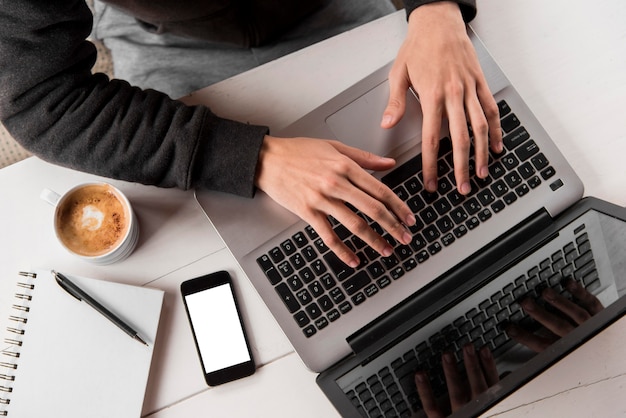 Close-up hands typing on keyboard