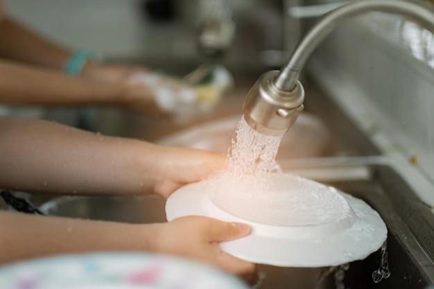 Close up hands washing dishes