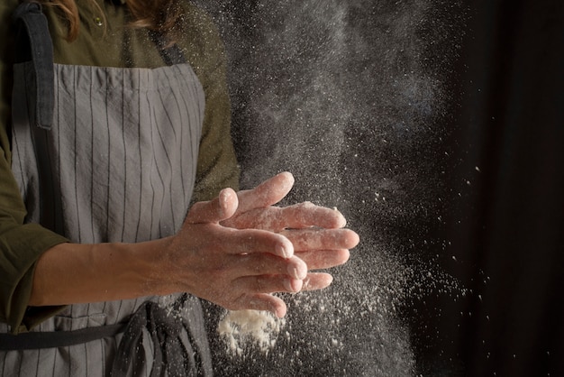 Close up hands with flour