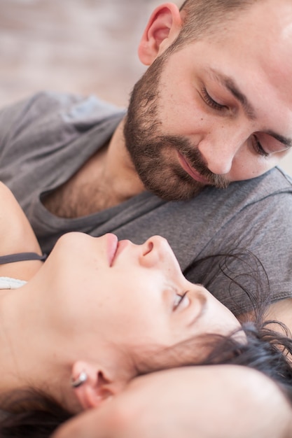 Close up of handsome husband looking at his wife after waking up.