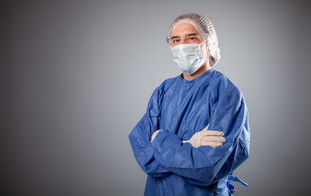 Close up on handsome male surgeon dressed in protective suit