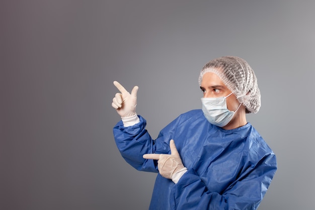 Close up on handsome male surgeon dressed in protective suit