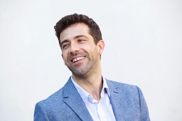 Close up handsome man smiling against white background