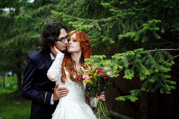 Close-up of happy boho wedding couple