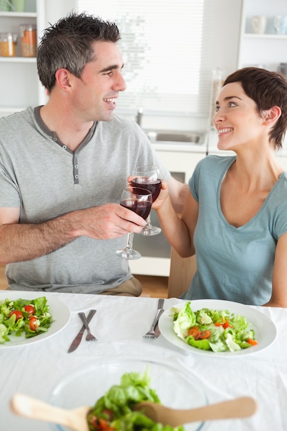 Close up of a Happy couple toasting with redwine