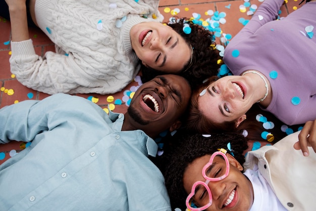 Close up happy friends with confetti