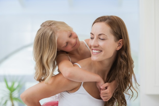 Close-up of a happy woman carrying girl