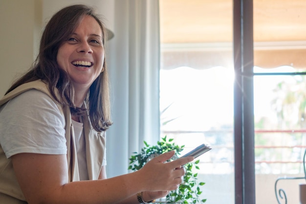 Close up of a happy woman using a mobile phone