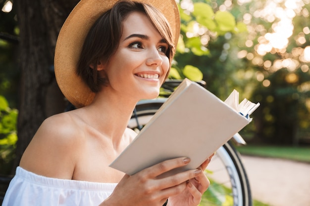 Close up of happy young girl reading a book