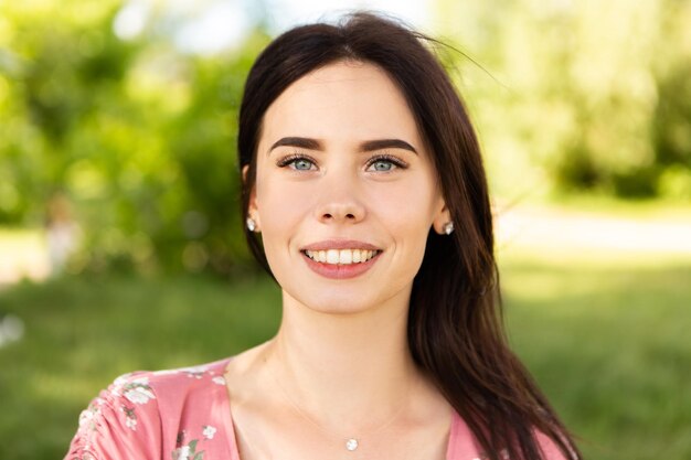 Close up head portrait of smiling caucasian woman with white teeth looking at the camera