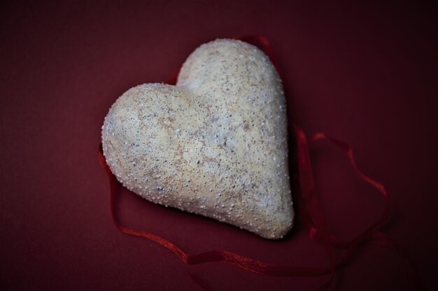 Close-up of heart shape on rock against black background