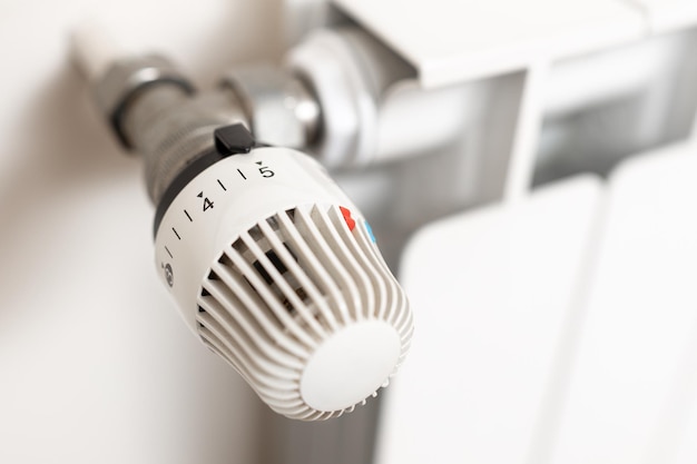 Close up of heating radiator thermostat showing maximum temperature Concept of waste in heating