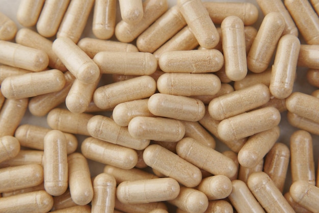 Close up of herb capsule nutritional supplement on table