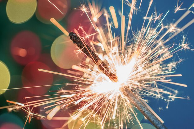 Close-up of holiday Christmas sparkler on dark background