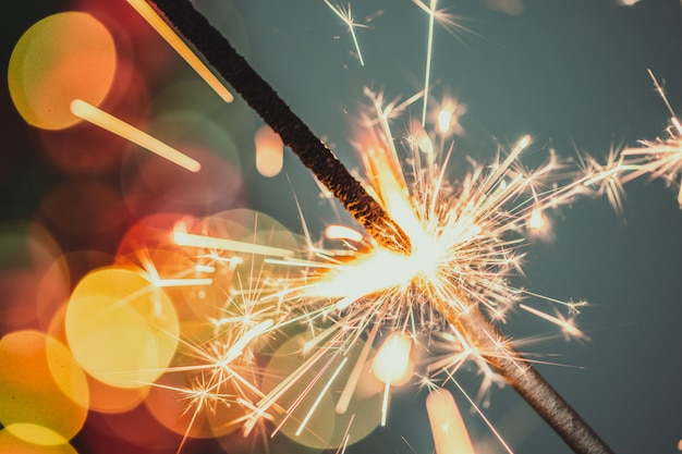 Close-up of holiday Christmas sparkler on dark 