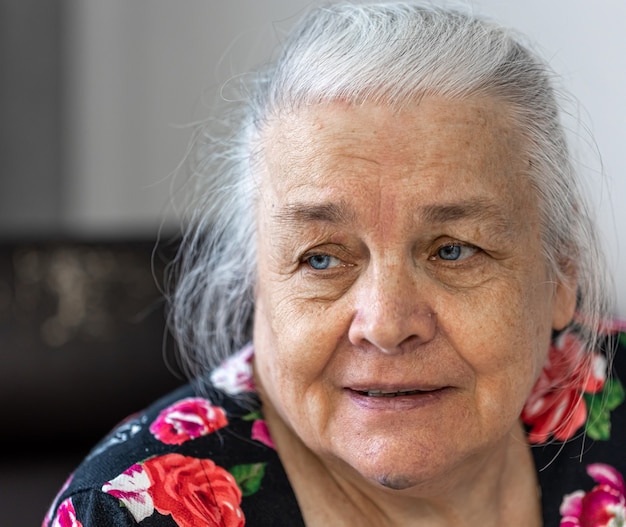 Close up home portrait of cute elderly woman.