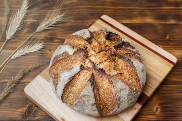 Close up of homemade whole grain sourdough bread on wooden board