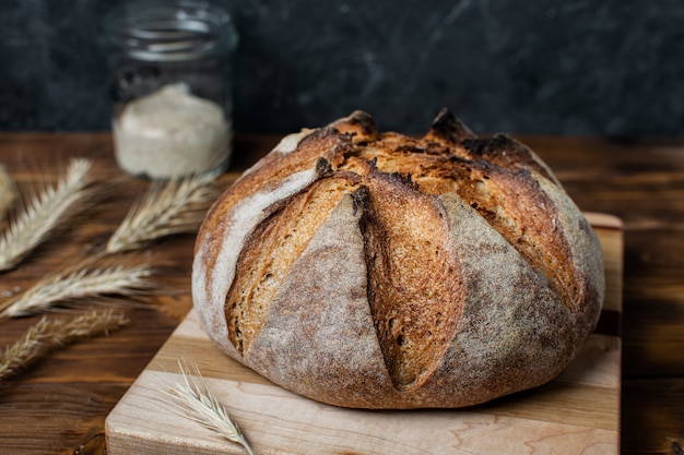 Close up of homemade whole grain sourdough bread on wooden board